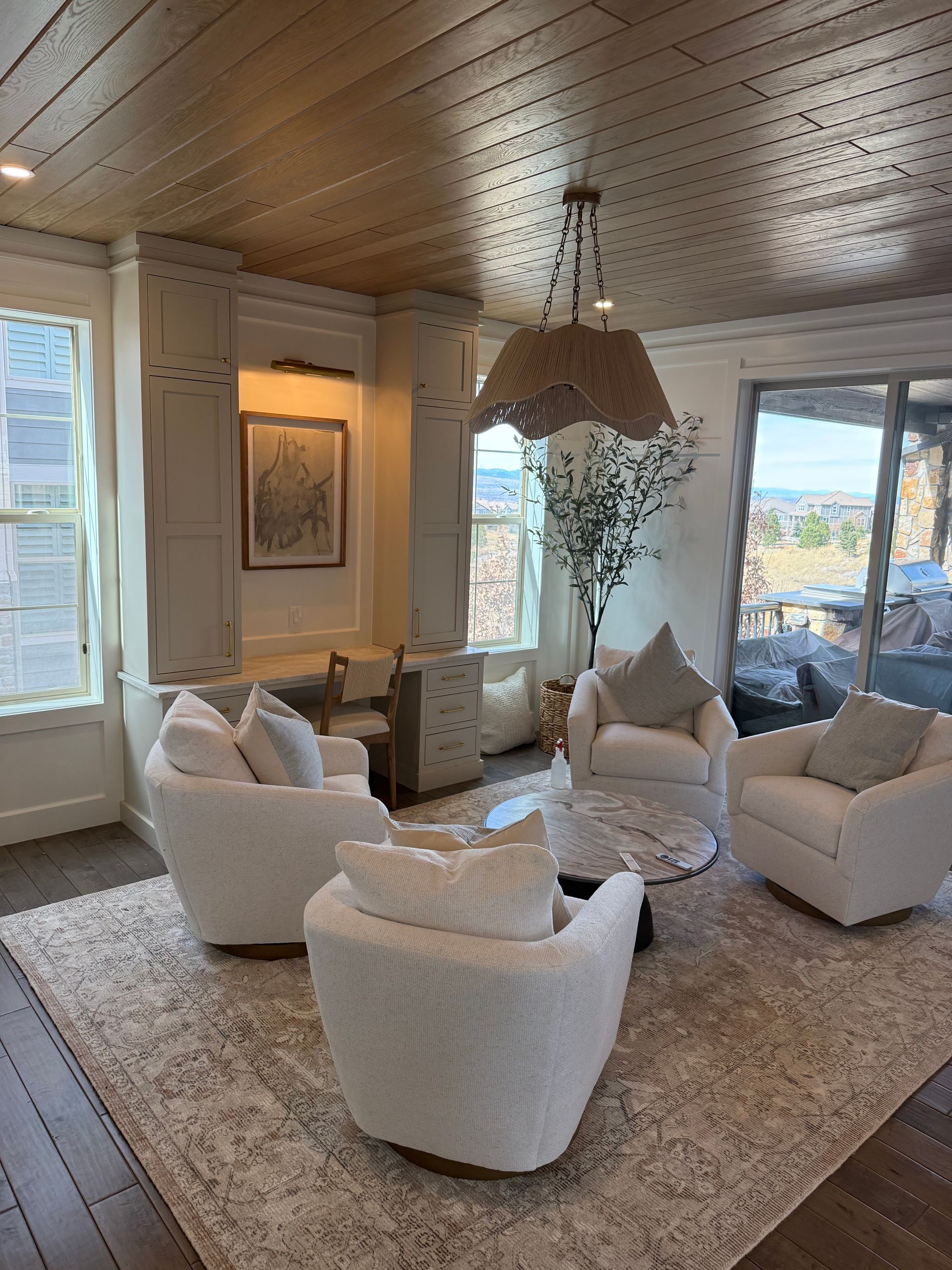 a kitchen with white cabinets and a large island in the middle .