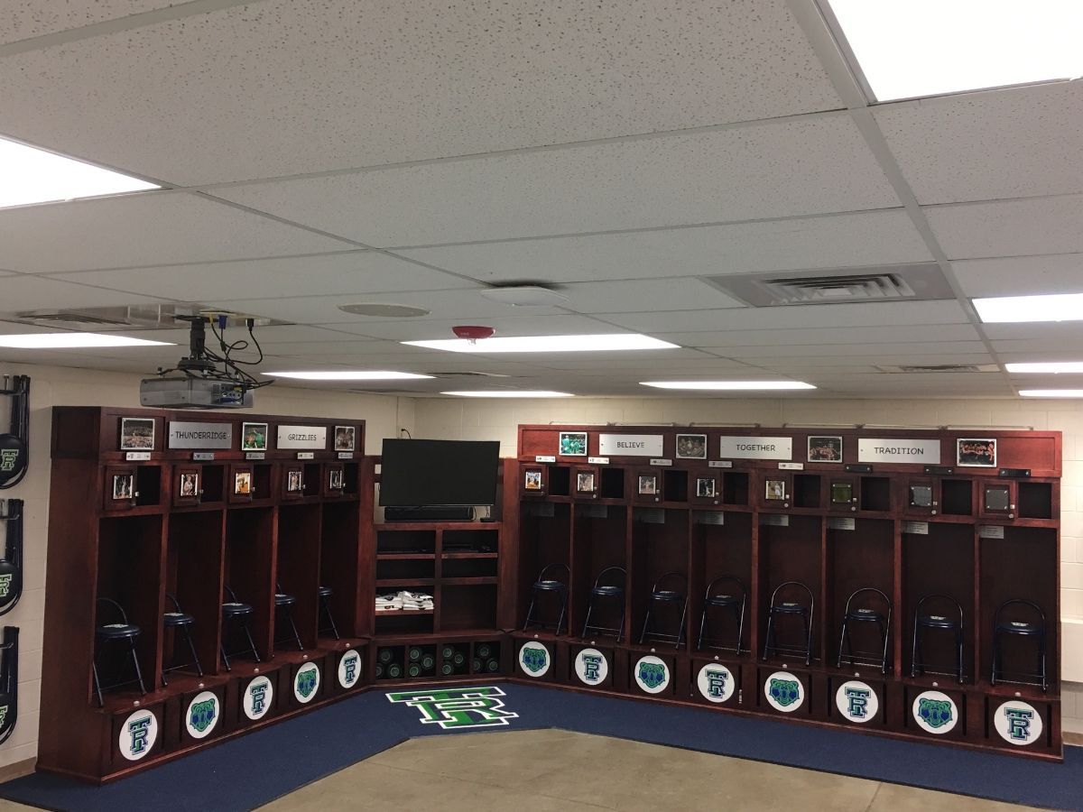 a locker room with a lot of shelves and a tv on the wall .