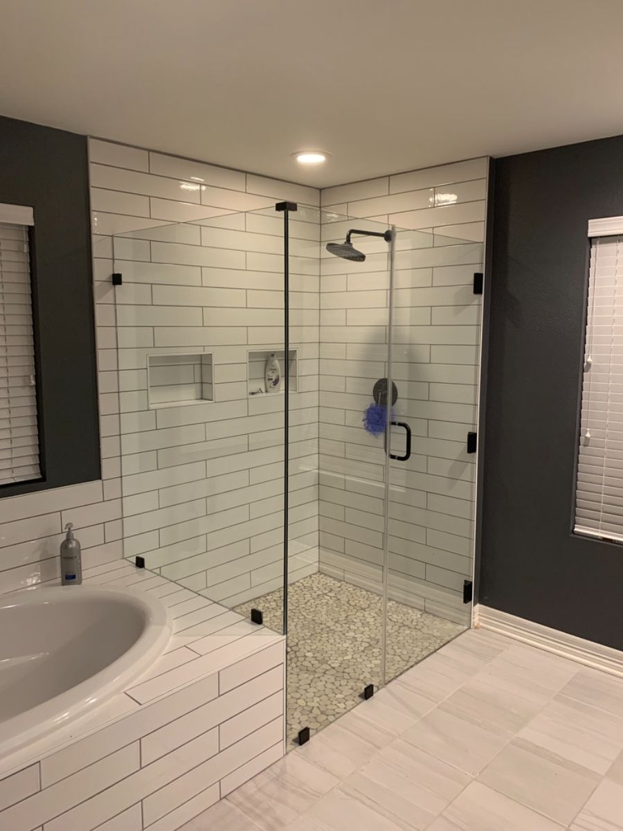 a bathroom with a walk in shower and a sink .