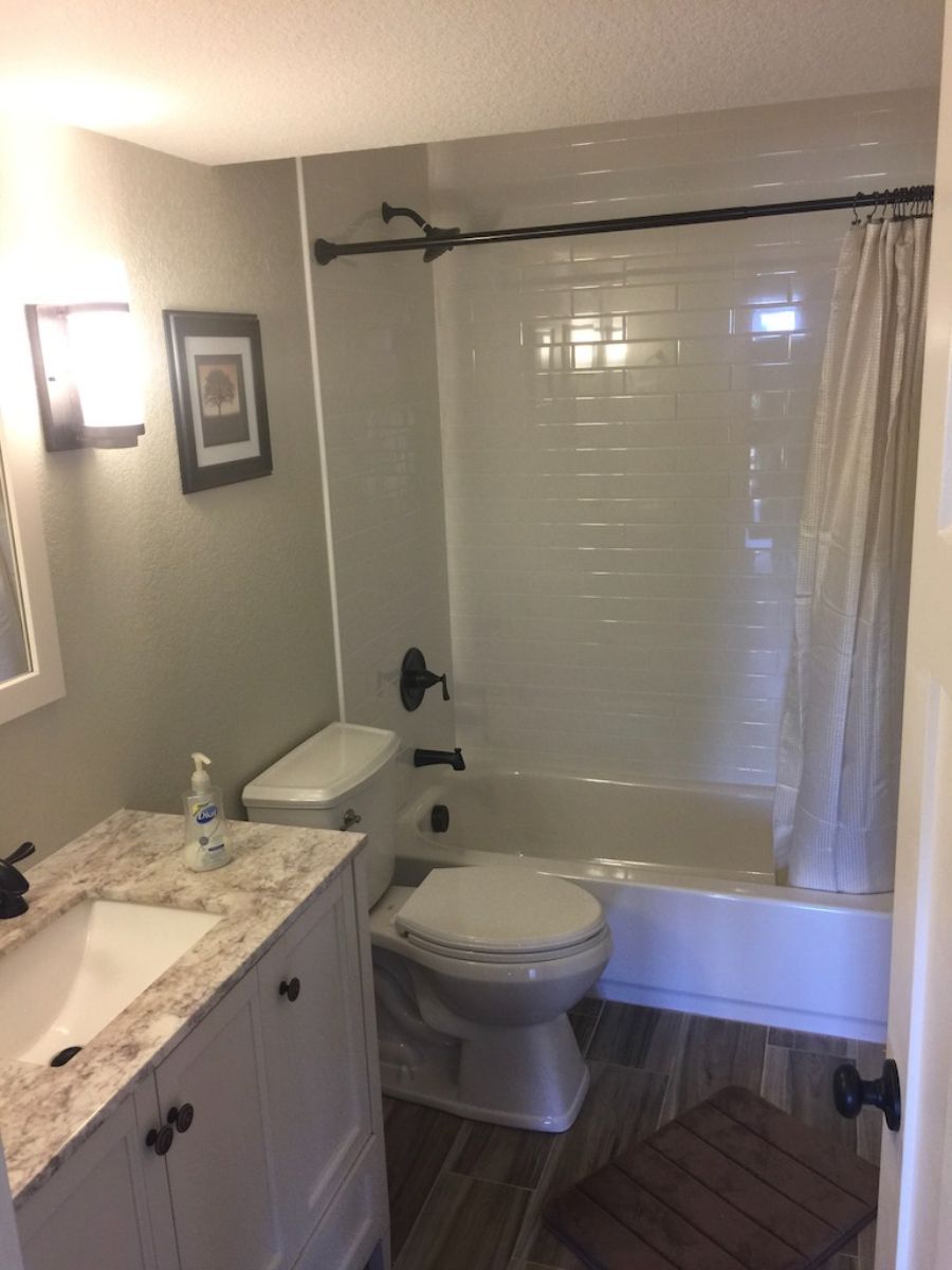 a bathroom with a toilet , sink and bathtub .