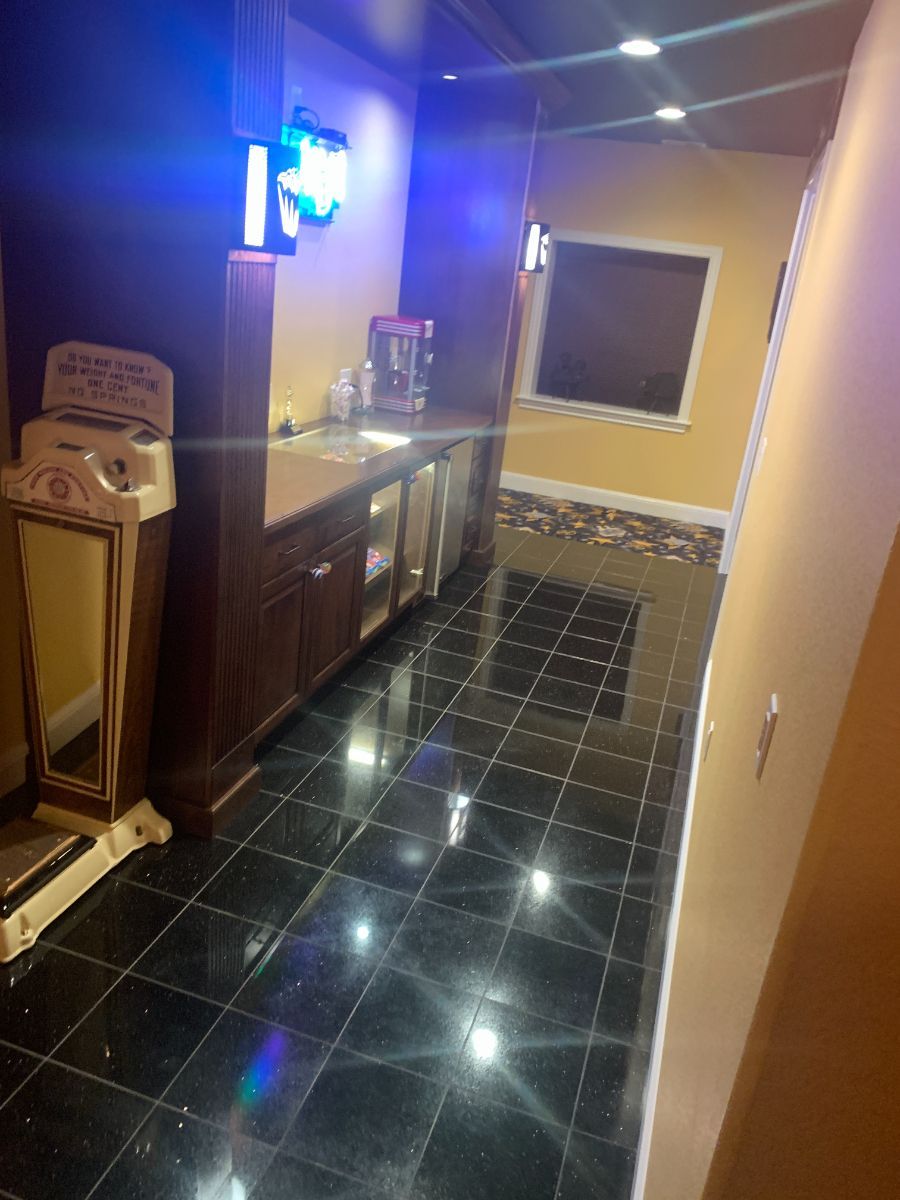 a kitchen with black tile floors and a sink