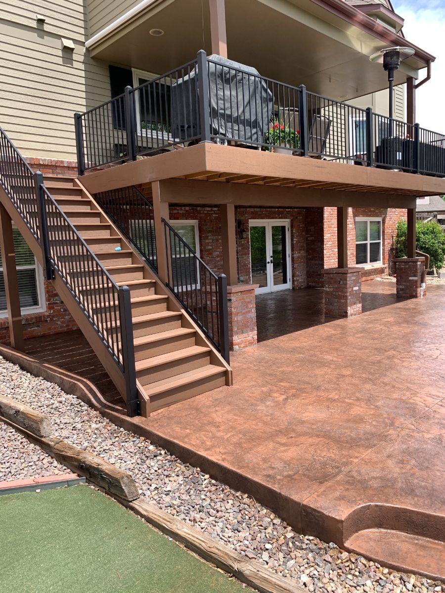 a house with a large deck and stairs leading up to it .