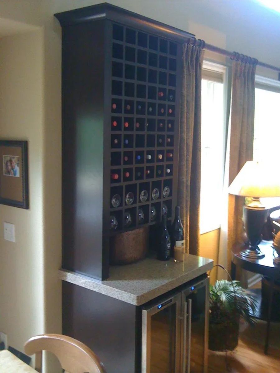 a kitchen with a wine rack and a refrigerator
