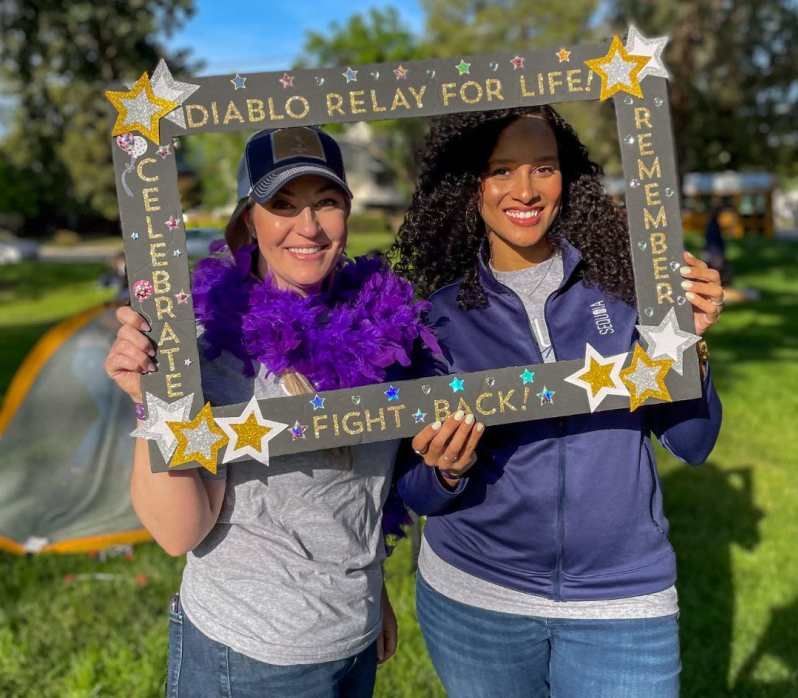 Two women holding a photo frame at 