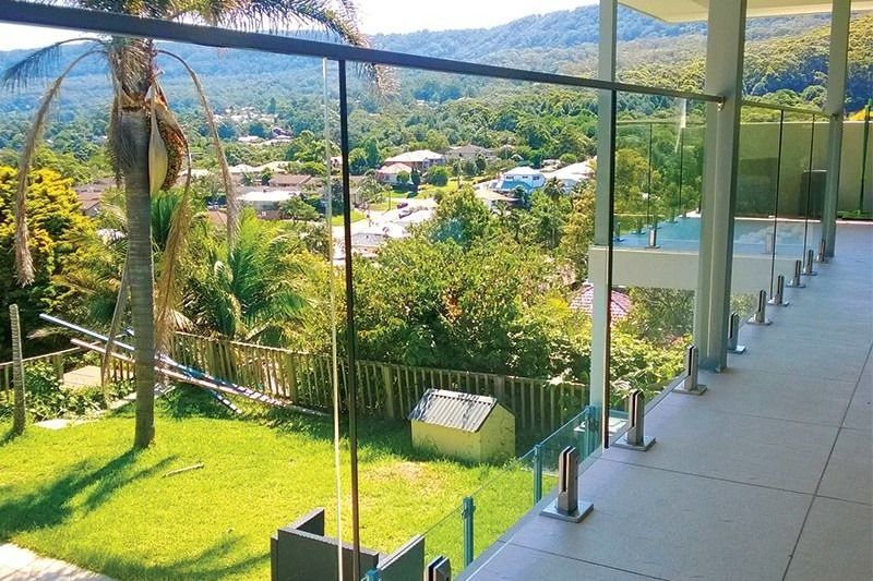A Balcony With A View Of A Lush Green Field And Mountains — Dimension One Glass Fencing In Central Coast, NSW