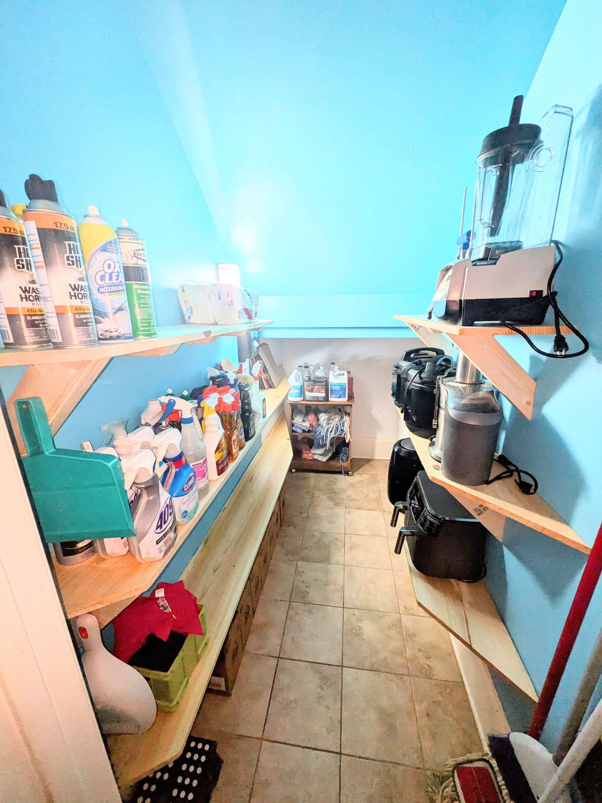 A room with a lot of shelves and bins in it