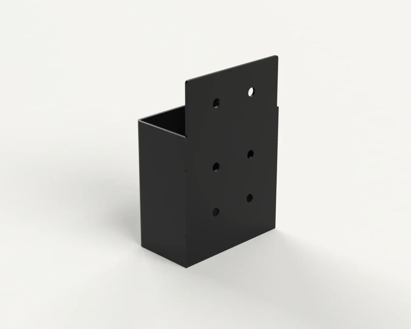 A black box with holes in it is sitting on a white surface.