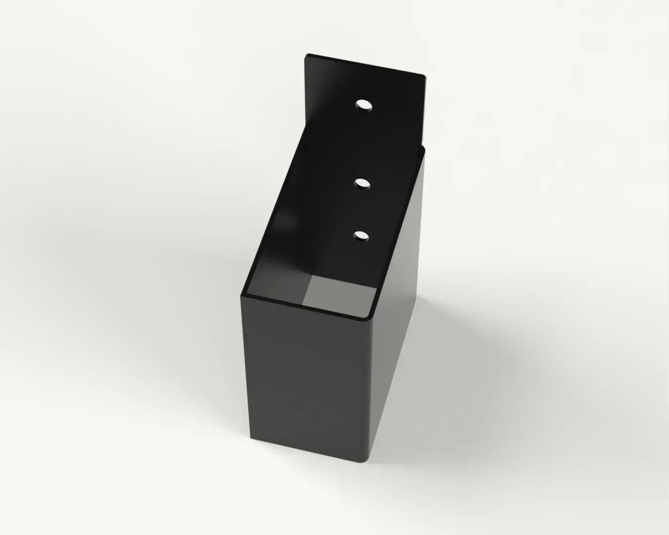 A black box with holes in it is sitting on a white surface.