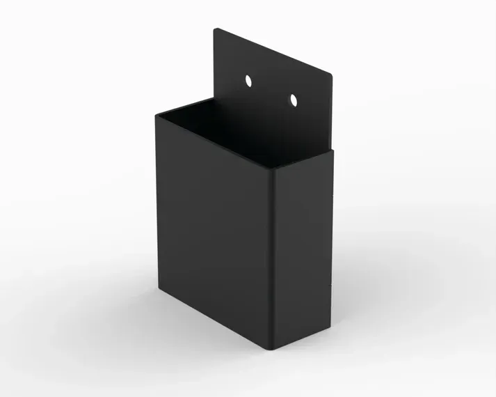 A black metal box is sitting on a white surface.