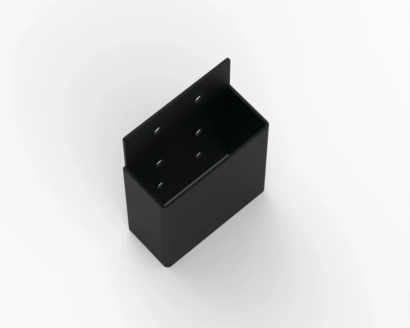 A black box with holes in it is sitting on a white surface.