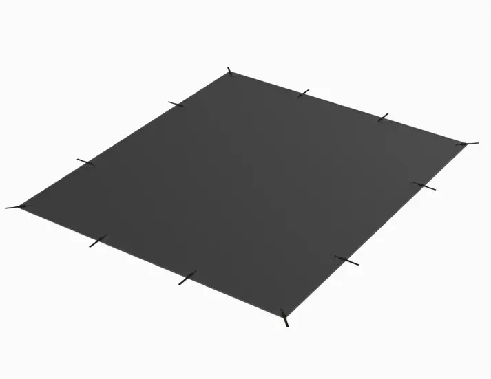 A black tarp is sitting on top of a white surface.