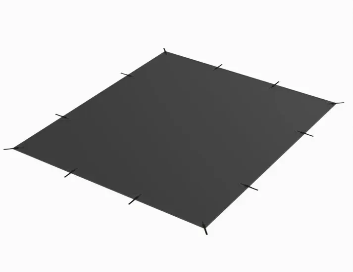 A black tarp is sitting on top of a white surface.