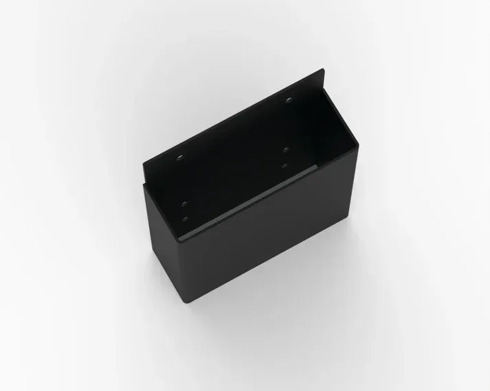 A black box is sitting on a white surface.
