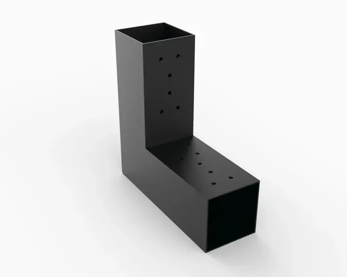 A black square with holes in it is sitting on a white surface.