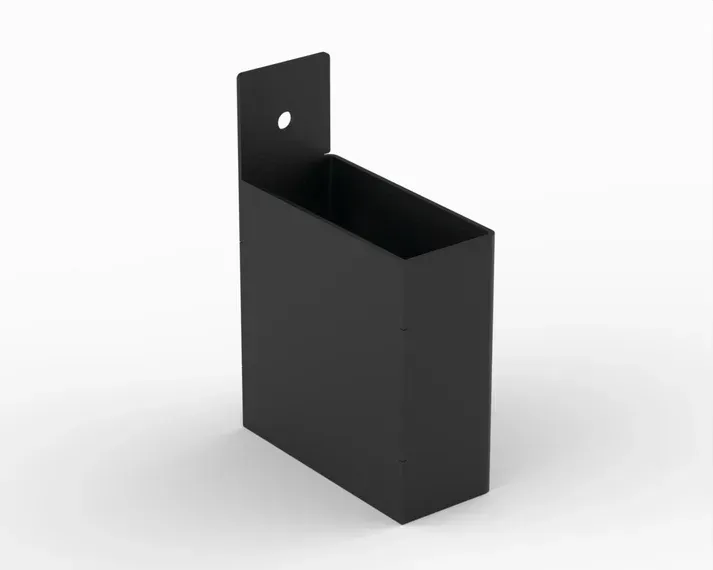 A black box with a hole in the side is sitting on a white surface.