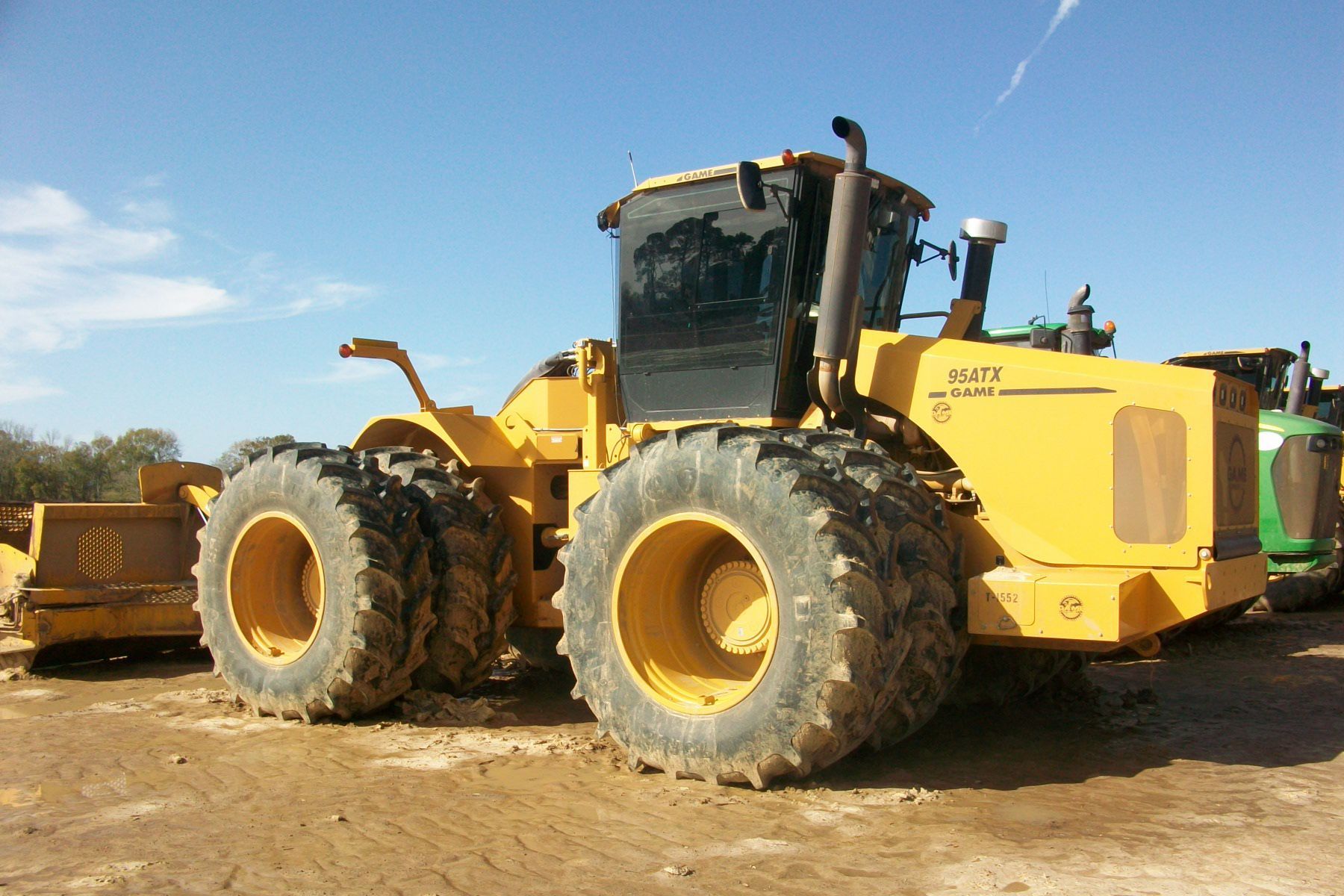 A yellow tractor with the word blak on the side.