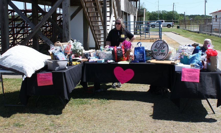 A man stands behind a table with a pink heart on it