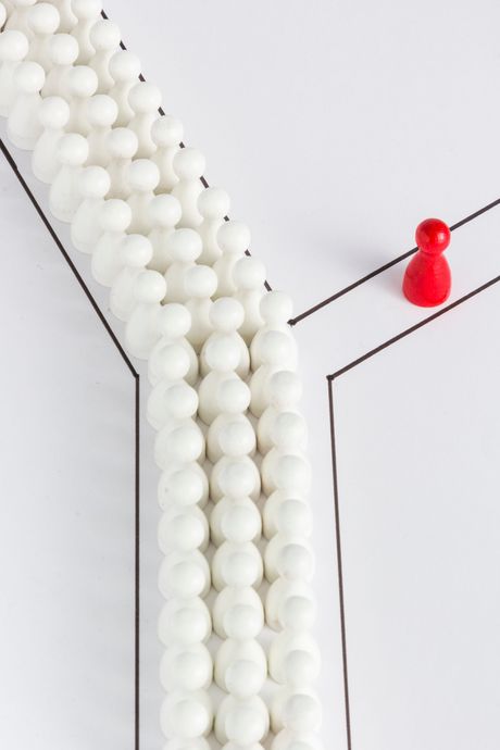 A row of white beads with a red pin in the middle