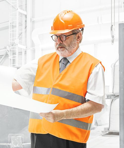 A man wearing an orange vest and hard hat is holding a piece of paper.