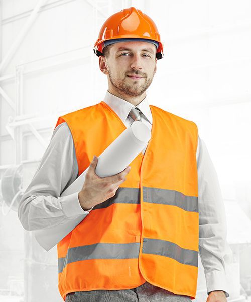 A man wearing an orange vest and hard hat is holding a blueprint.