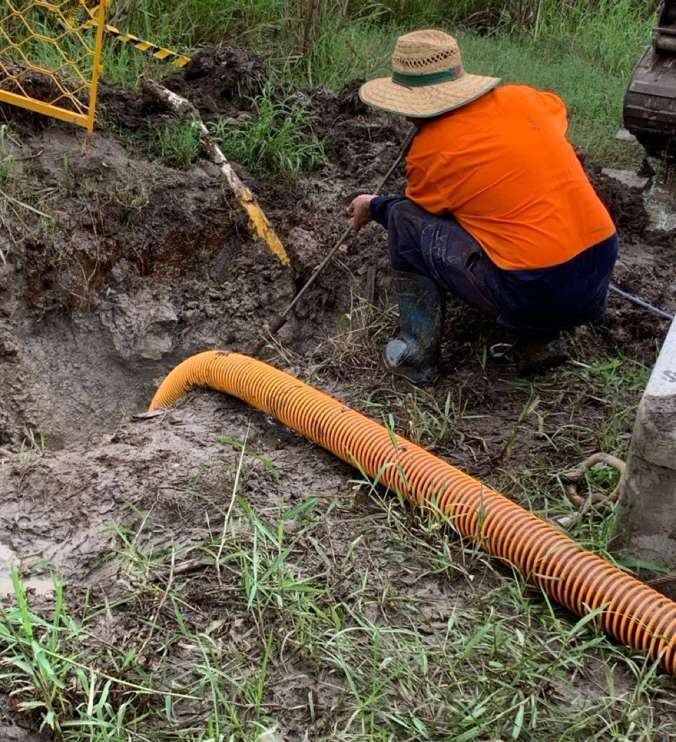 Close view of a worker doing Hydrovac on a green lawn.