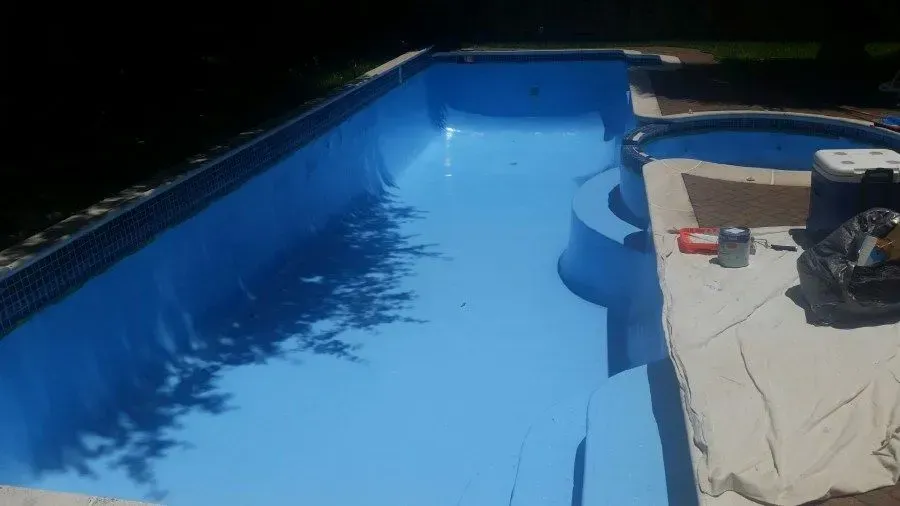 Freshly painted light blue swimming pool and spa.