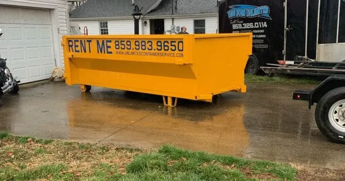 Dumpster rental Lexington KY roll-off container placed on residential driveway