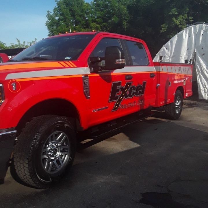 A red truck with the word excel on the side