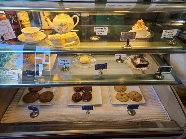 A glass display case filled with a variety of desserts
