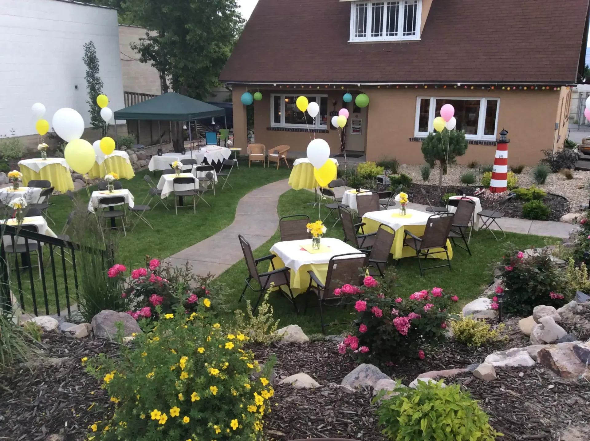 A house with tables and chairs in front of it