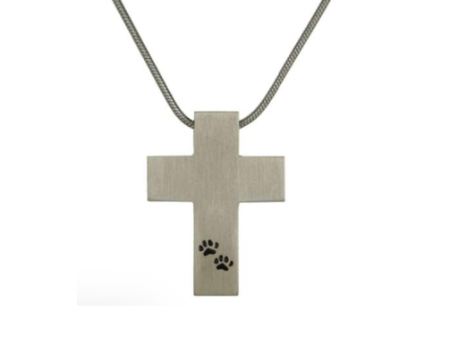 Silver cross pendant necklace with small black paw prints on the lower stem