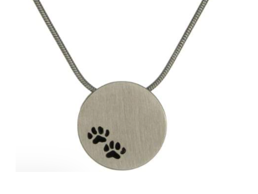 Round silver pendant necklace with two black paw prints
