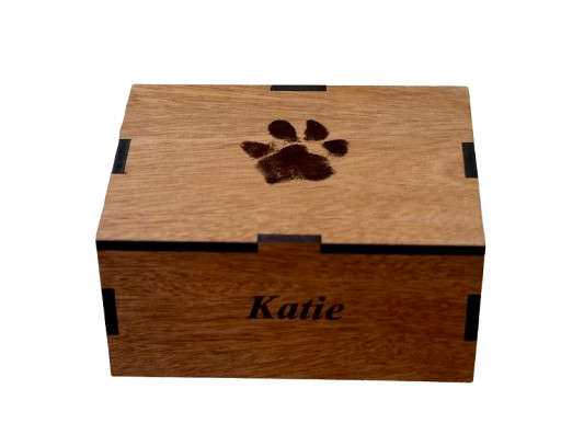 Wooden box with a paw print on top and the name “Katie” on the front.