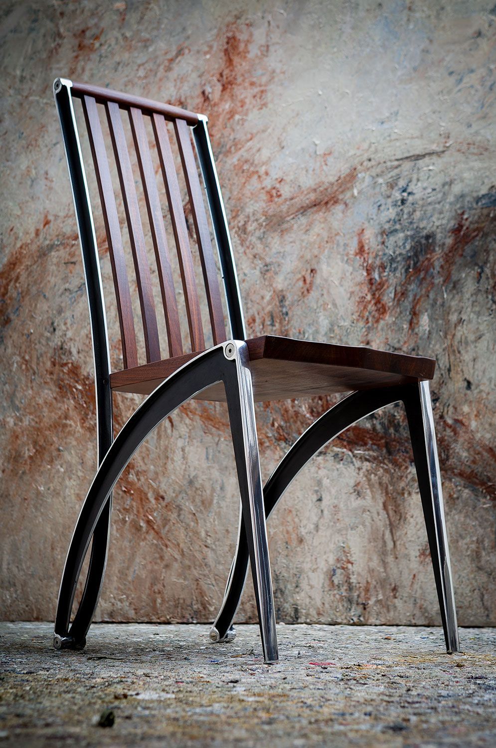 traditional mantide dining chair walnut chair with a metal frame is sitting in front of a wall.