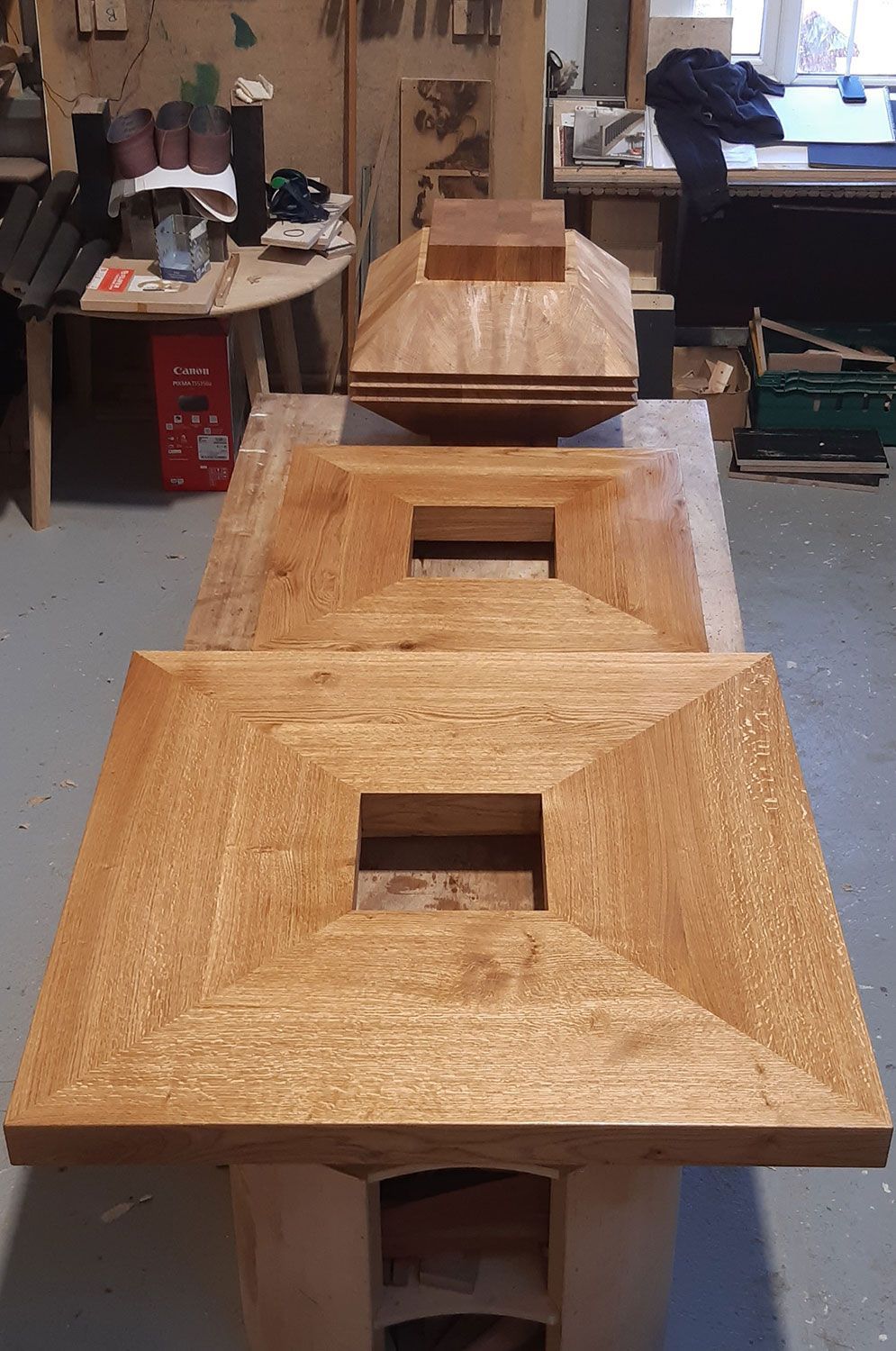 A stack of handmade wooden pieces sitting on top of each other on a table.