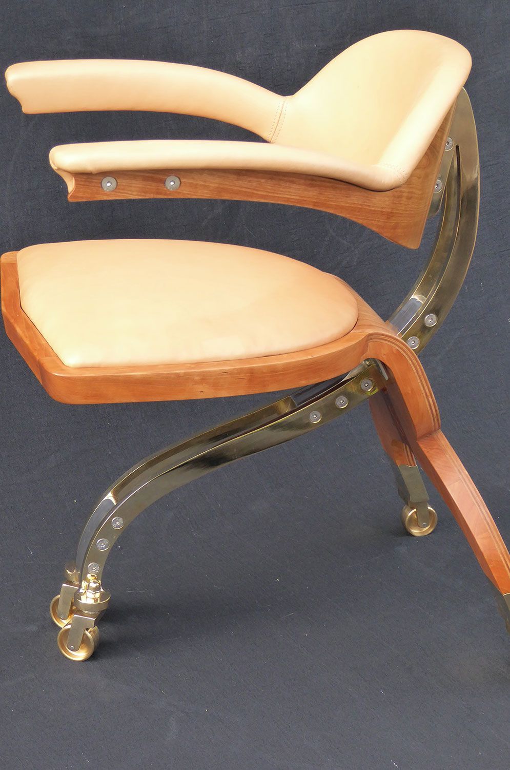 A creative designer wooden chair with a tan cushion and clear legs