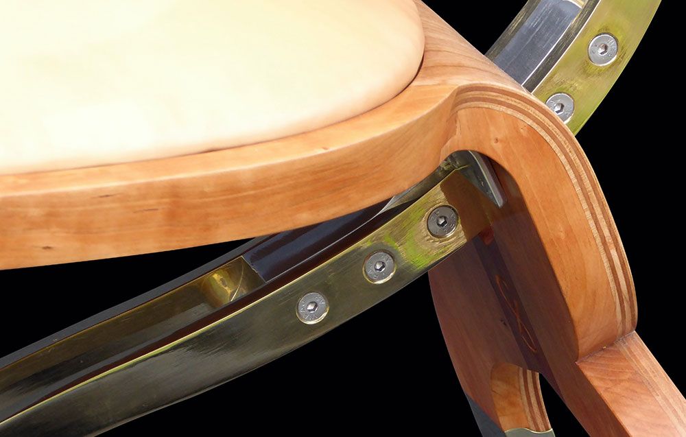 A close up of a creative wooden chair with a metal frame designed by sebastian blakeley