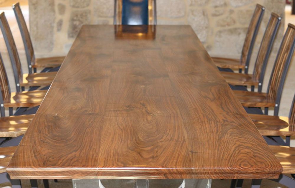 A handcrafted walnut wooden table and chairs set. high end furniture