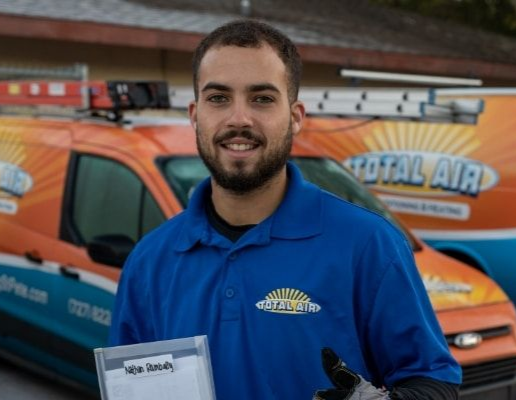 White John C. Cassidy service van parked near a PBKC sign under a cloudy sky
