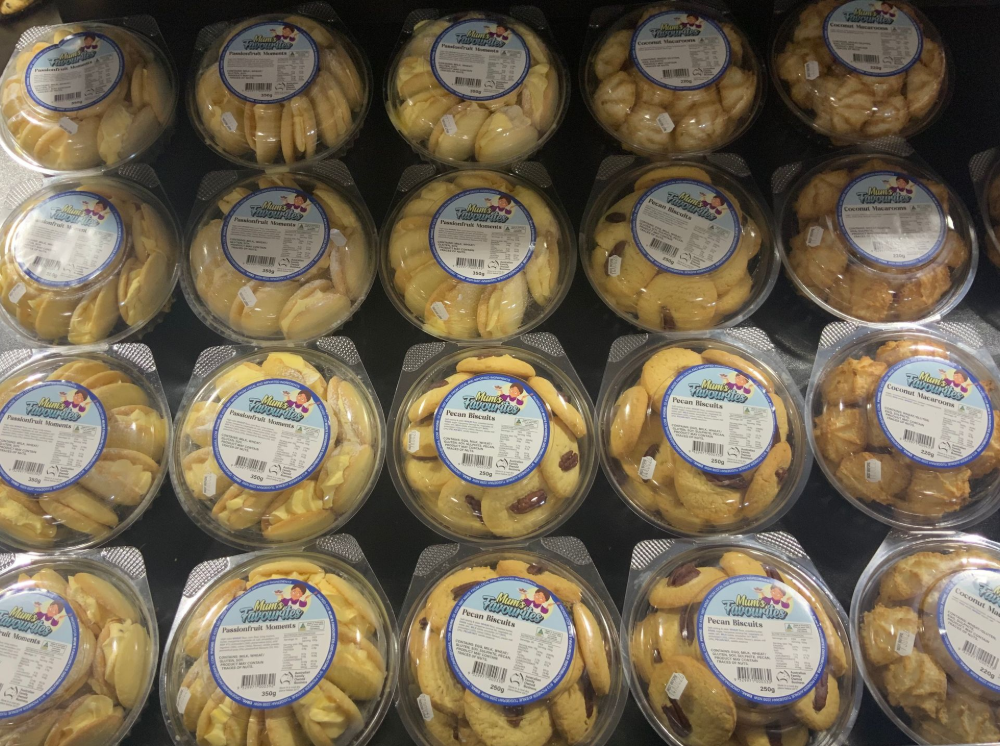 Stacked round pastry packages in plastic trays, wrapped in clear film with white labels — Cedar Park Supermarket In Taranganba, QLD