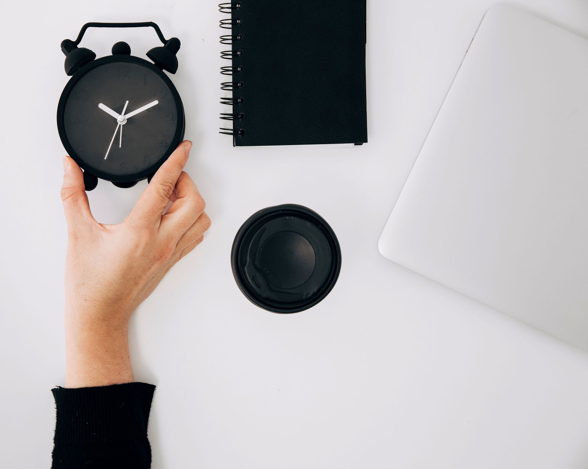 Close Up Person's Hand Holding Black Clock