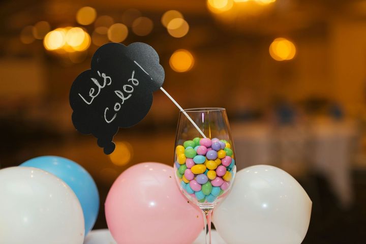 Balloon-themed candy display with pastel balloons, a glass jar of colorful sweets, and a chalkboard sign.