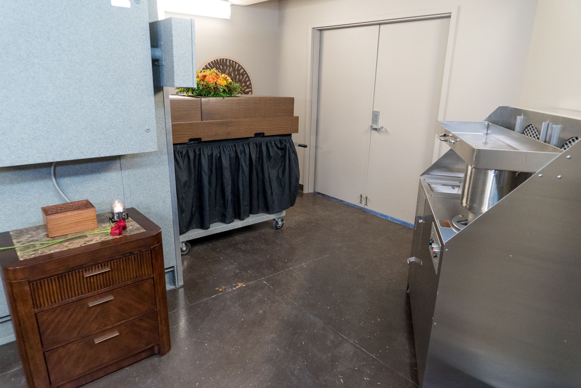 A room with a dresser and a sink in it.