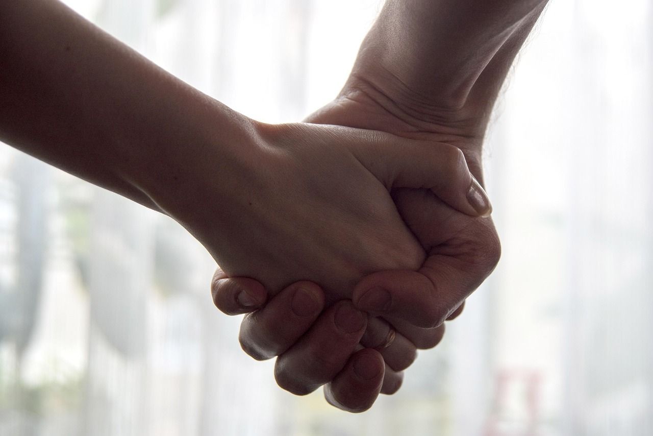 Two people holding hands to represent comfort, care, and grief support from funeral homes Chaska, MN.