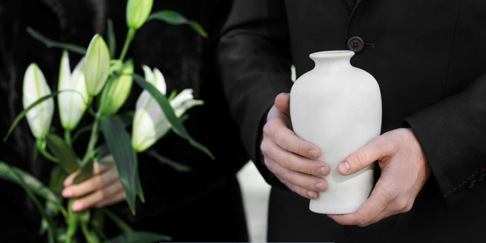 Family holding an urn and lilies for cremation services in Jordan, MN.