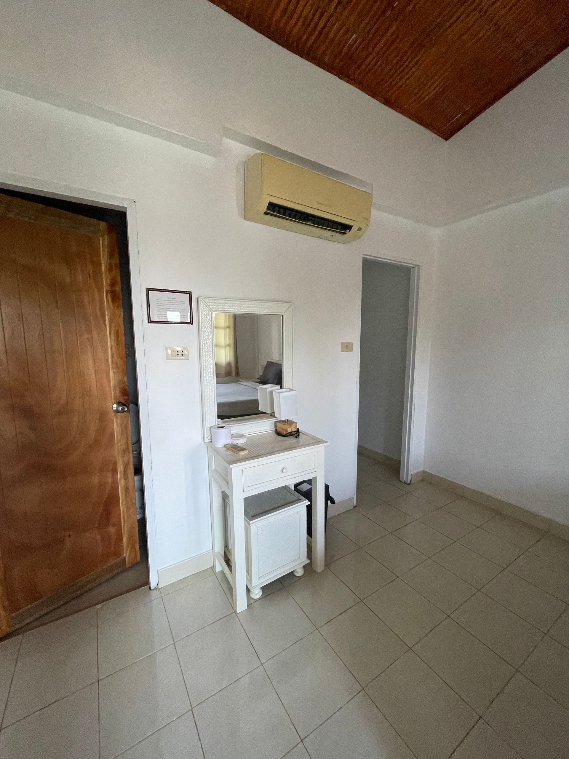 bathroom and vestiare with fridge and clothes hangers
