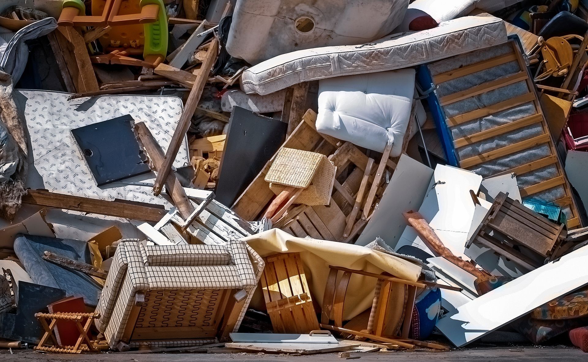 A pile of broken furniture is sitting on the ground.