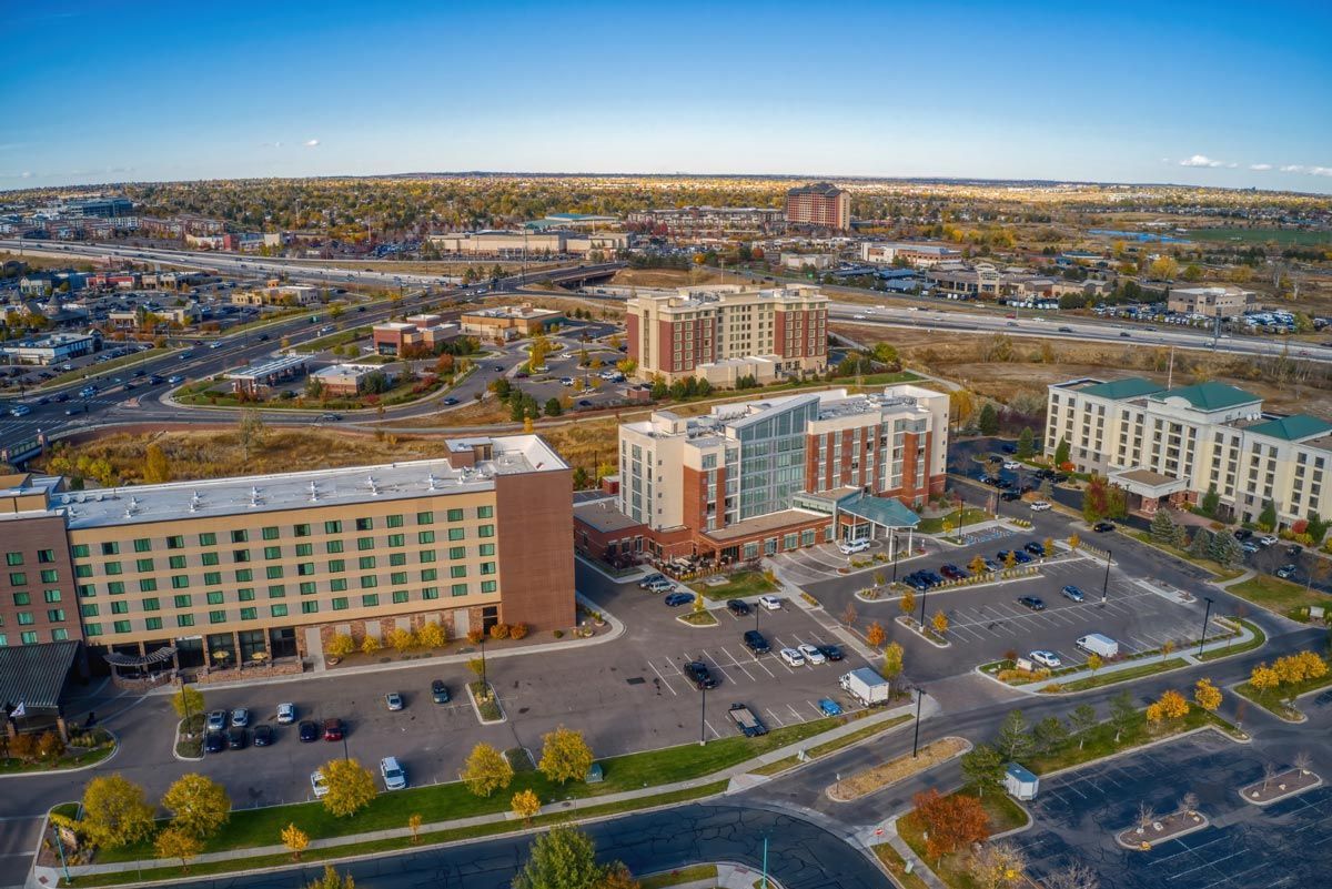 An aerial view of a city with a lot of buildings and a parking lot.