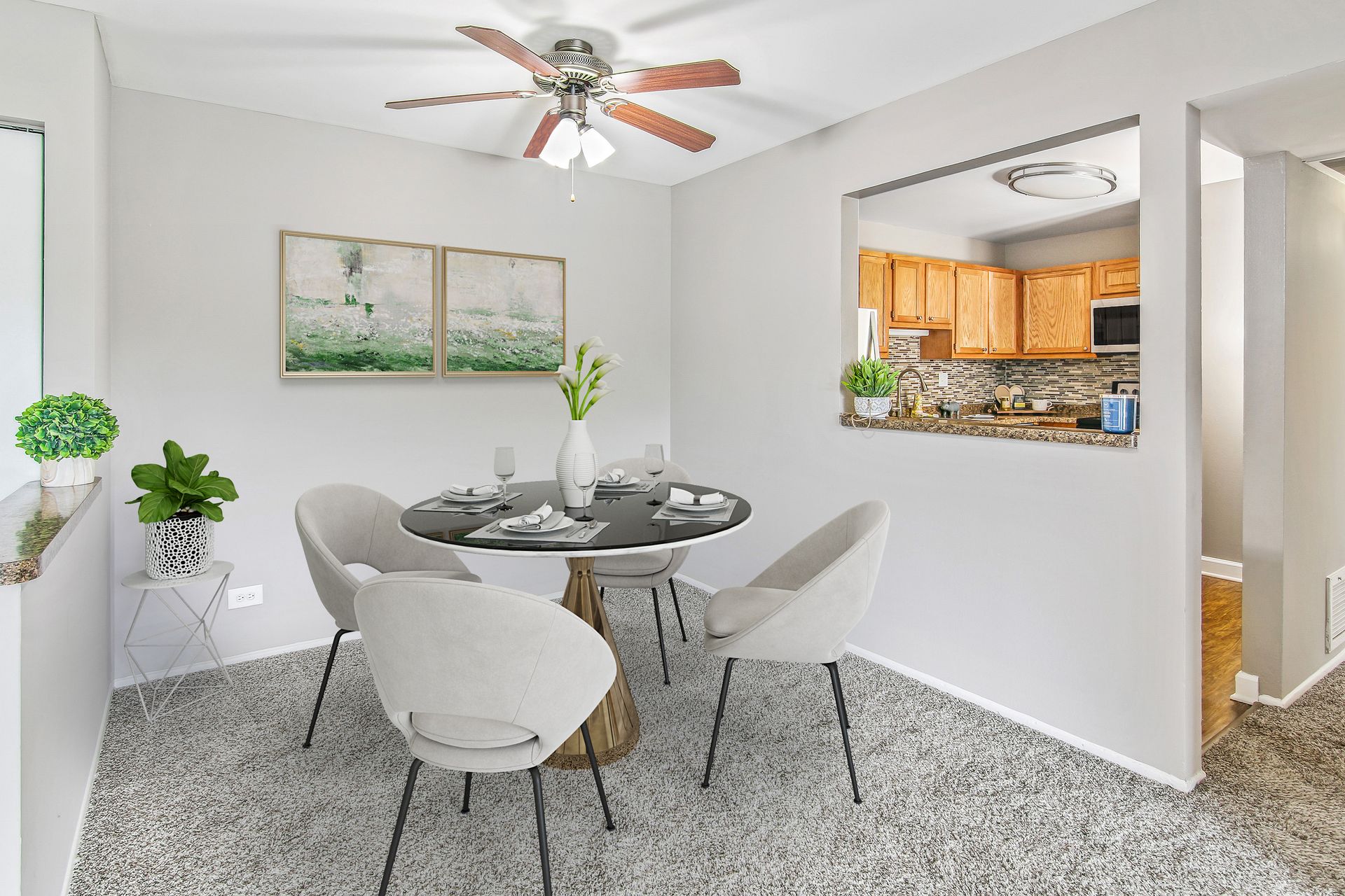 a dining room with a table and chairs and a ceiling fan .