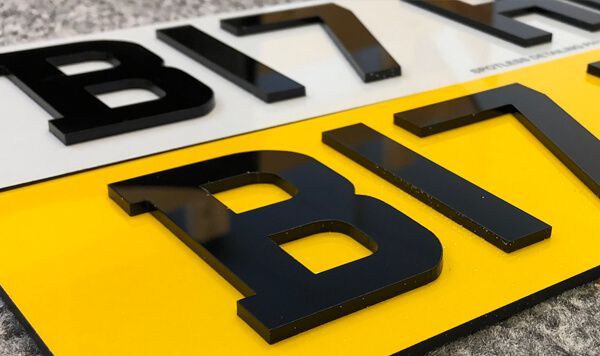 A close up of a yellow and white license plate that says b17